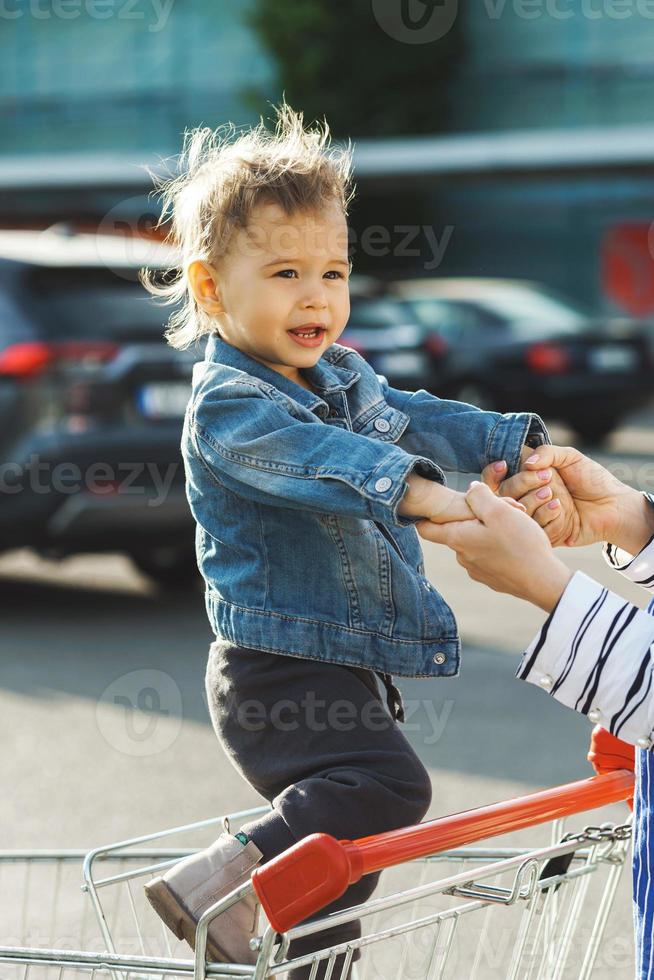 Cute little boy in a shopping cart photo