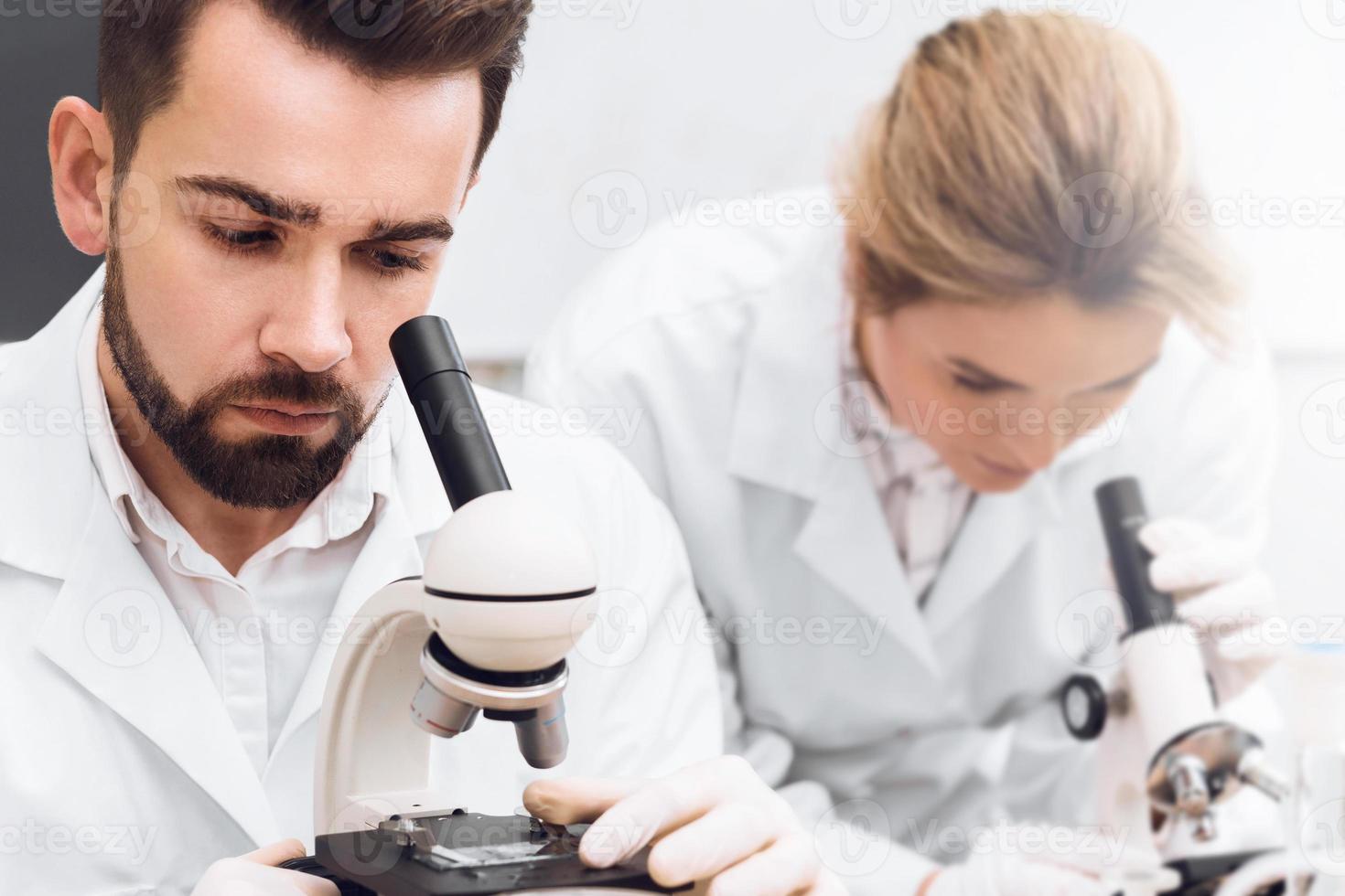 Students are working in a laboratory using microscopes during science research work photo