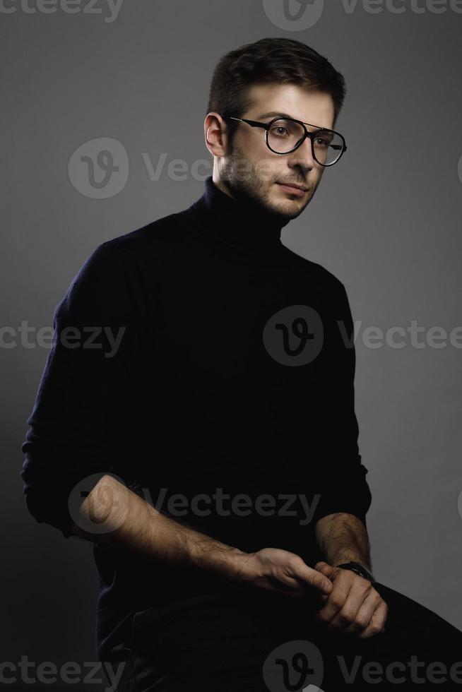 Young intelligent man wearing turtleneck and eyeglasses photo