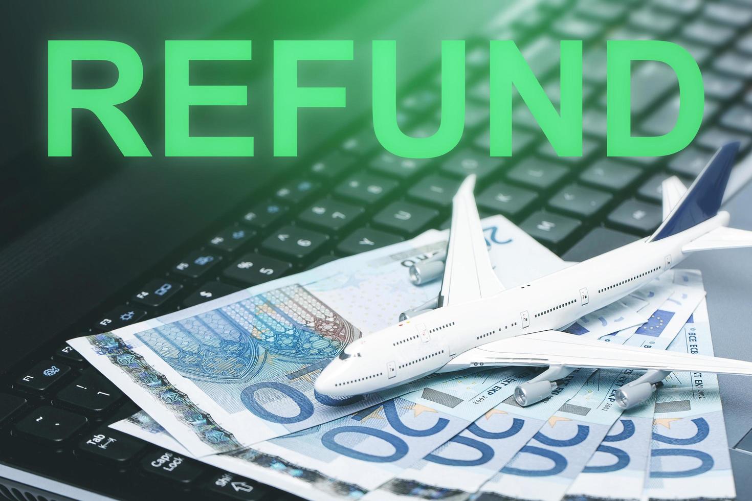 Flight ticket refund. Little toy airplane and euro banknotes photo