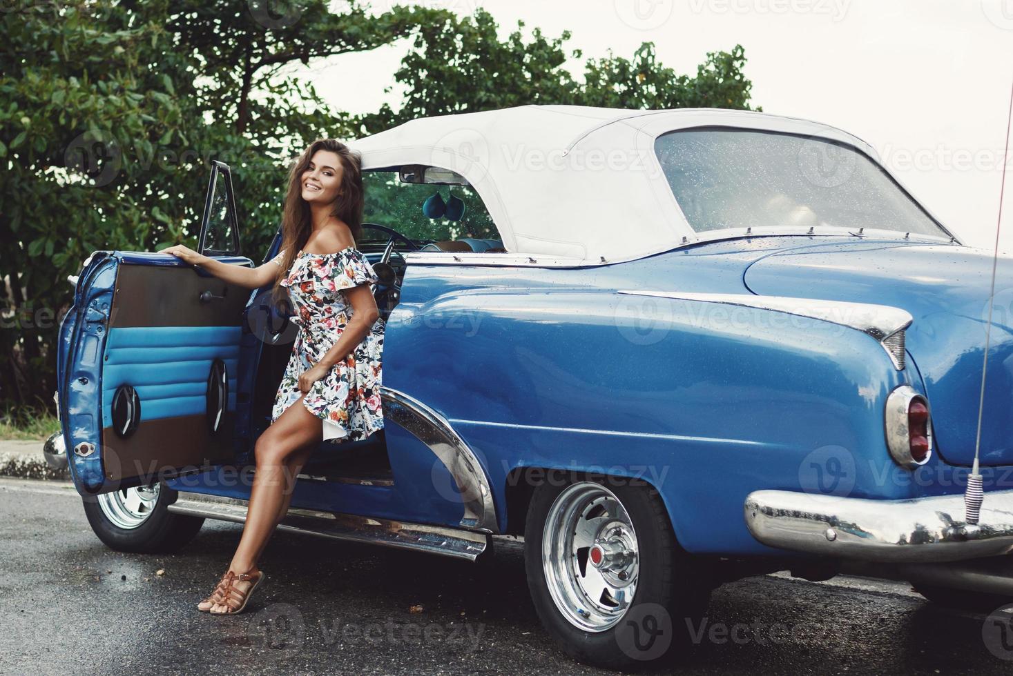 Beautiful woman driving a retro convertible car photo