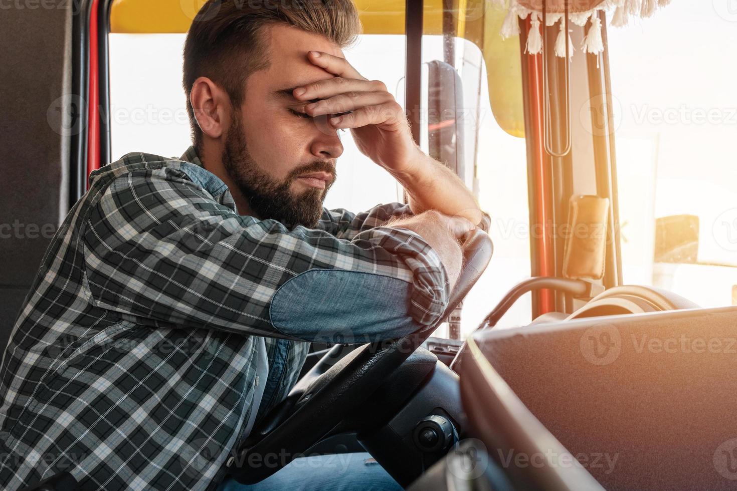 Tired truck driver feeling sleepy and sick photo