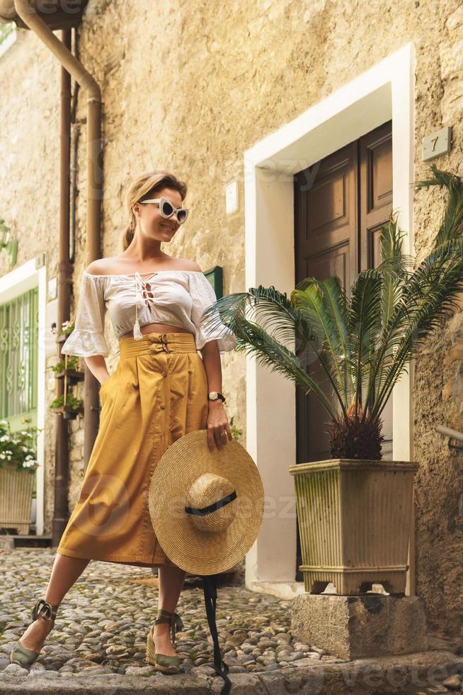 Young woman posing on the streets of small Italian town photo