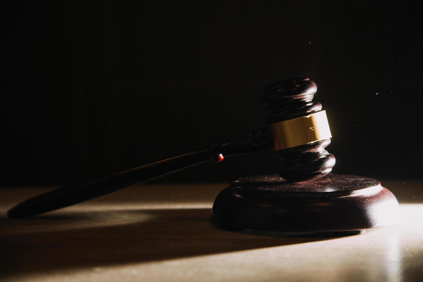 Business and lawyers discussing contract papers with brass scale on desk in office. Law, legal services, advice, justice and law concept picture with film grain effect photo