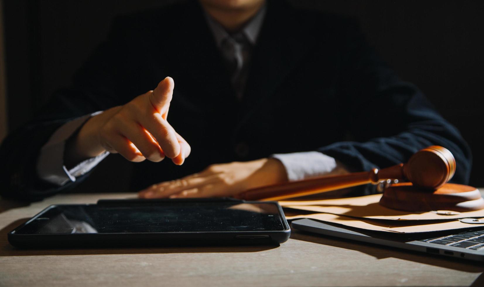 Business and lawyers discussing contract papers with brass scale on desk in office. Law, legal services, advice, justice and law concept picture with film grain effect photo