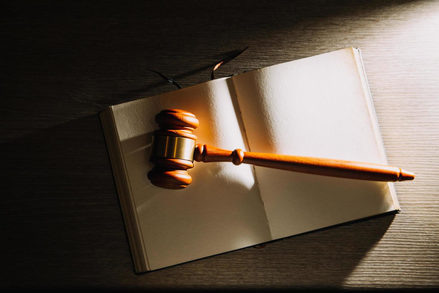 Business and lawyers discussing contract papers with brass scale on desk in office. Law, legal services, advice, justice and law concept picture with film grain effect photo