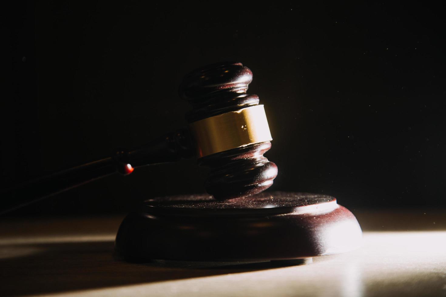 Business and lawyers discussing contract papers with brass scale on desk in office. Law, legal services, advice, justice and law concept picture with film grain effect photo