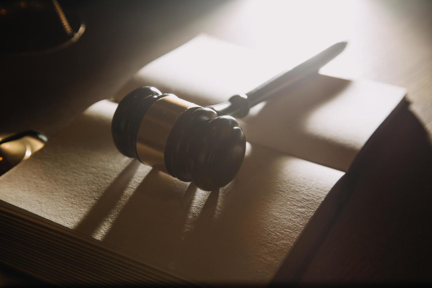 Business and lawyers discussing contract papers with brass scale on desk in office. Law, legal services, advice, justice and law concept picture with film grain effect photo