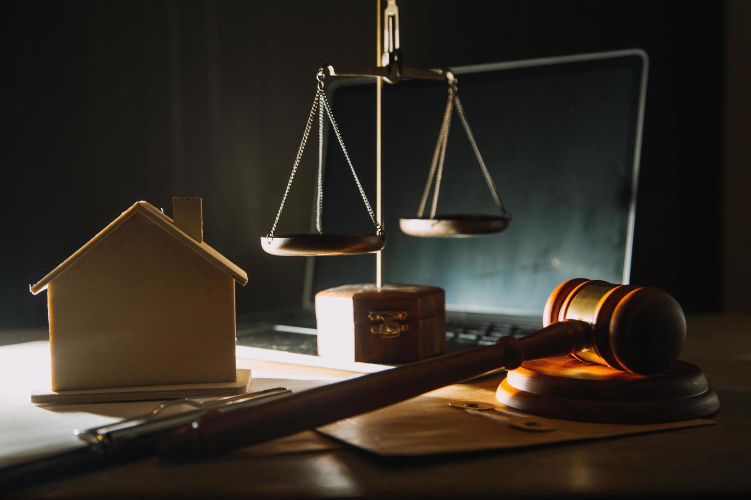 Business and lawyers discussing contract papers with brass scale on desk in office. Law, legal services, advice, justice and law concept picture with film grain effect photo