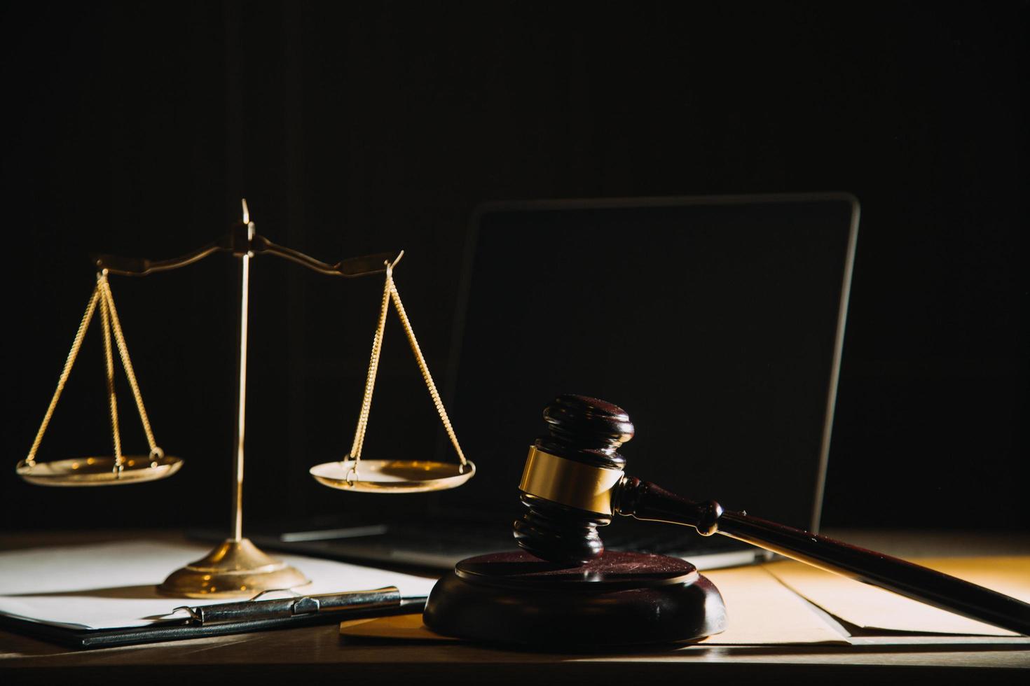 Business and lawyers discussing contract papers with brass scale on desk in office. Law, legal services, advice, justice and law concept picture with film grain effect photo