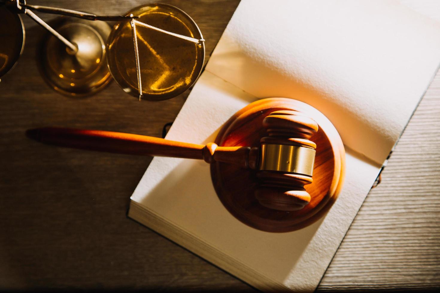 Business and lawyers discussing contract papers with brass scale on desk in office. Law, legal services, advice, justice and law concept picture with film grain effect photo