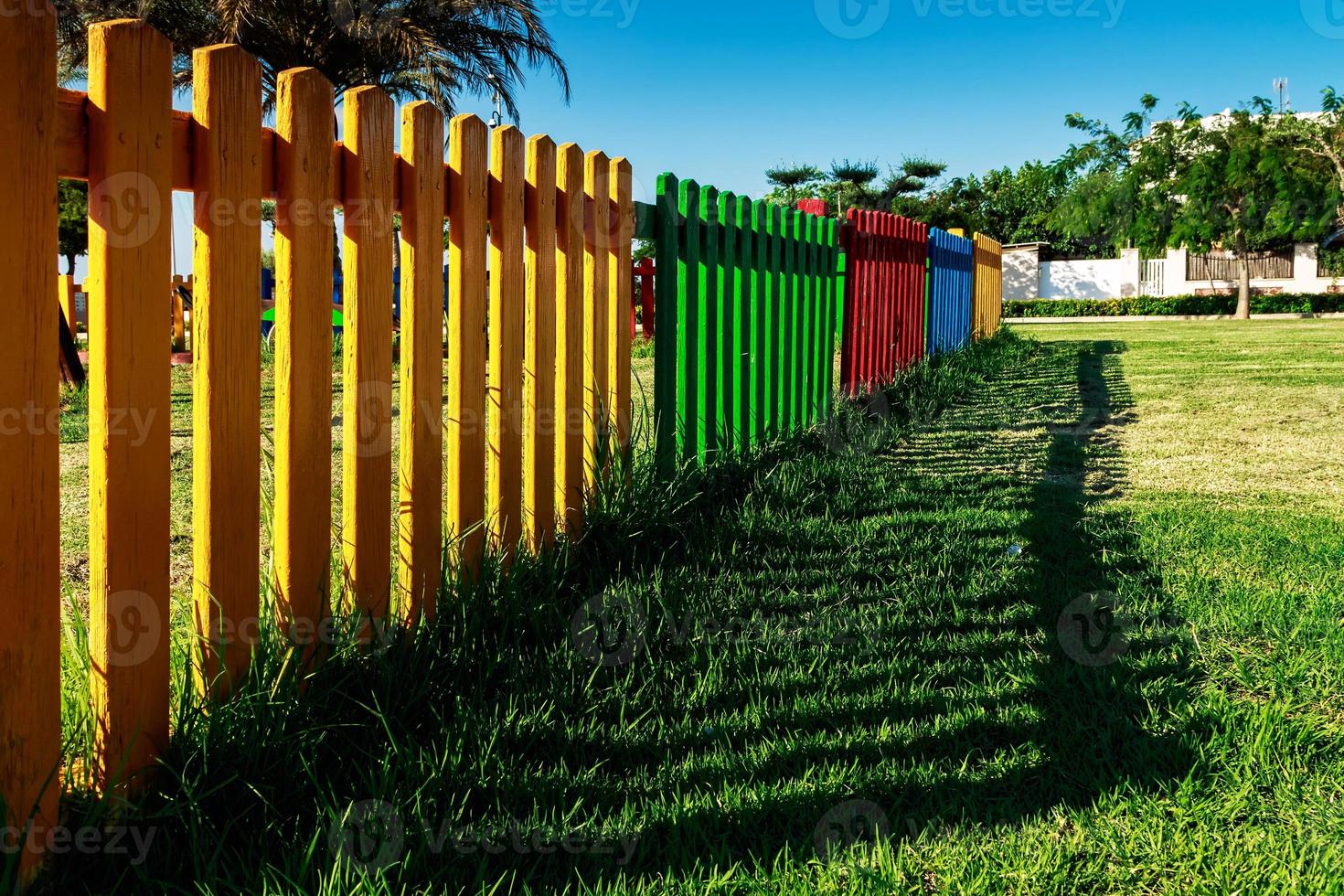 Colorful wooden fence of a playground. Horizontal image. photo