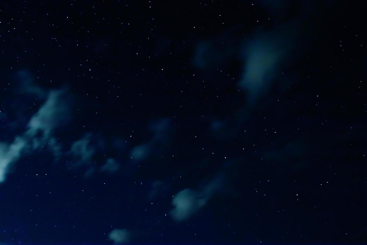 Night sky with stars and clouds in motion photo