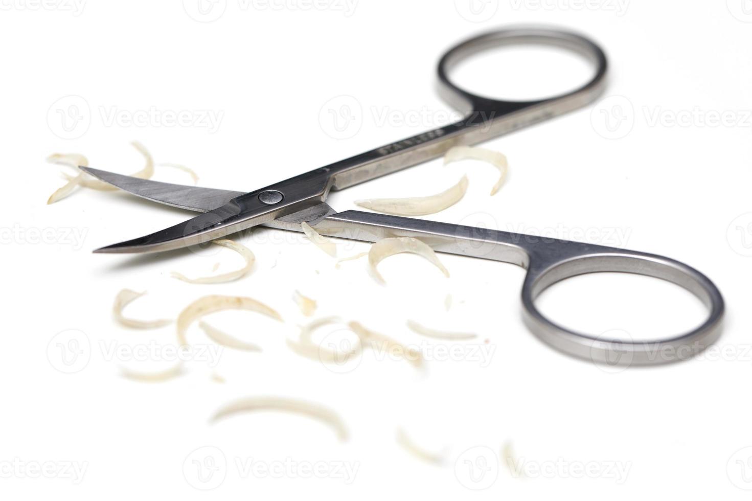 Manicure scissors and nail clipping on white background photo