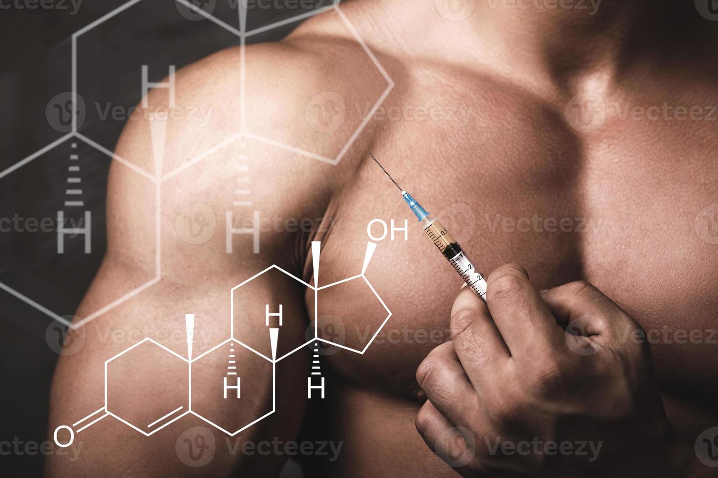 Muscular man with a syringe in his hand and testosterone formula. photo