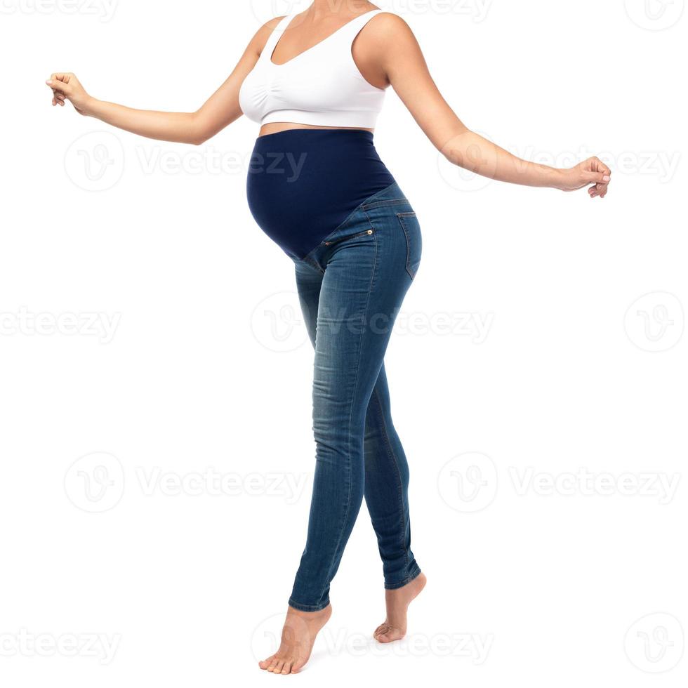 Young and pregnant woman wearing maternity jeans photo