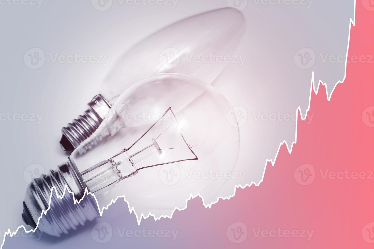 Light bulbs and rising chart representing current electricity price during energy crisis in the world photo