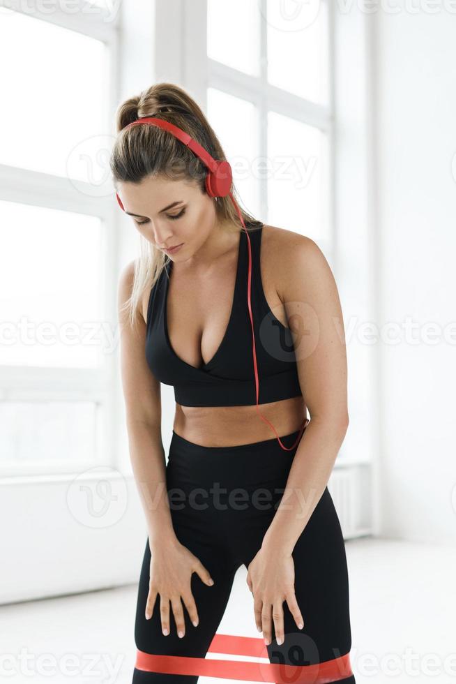 Young woman during her workout with a loop resistance band photo