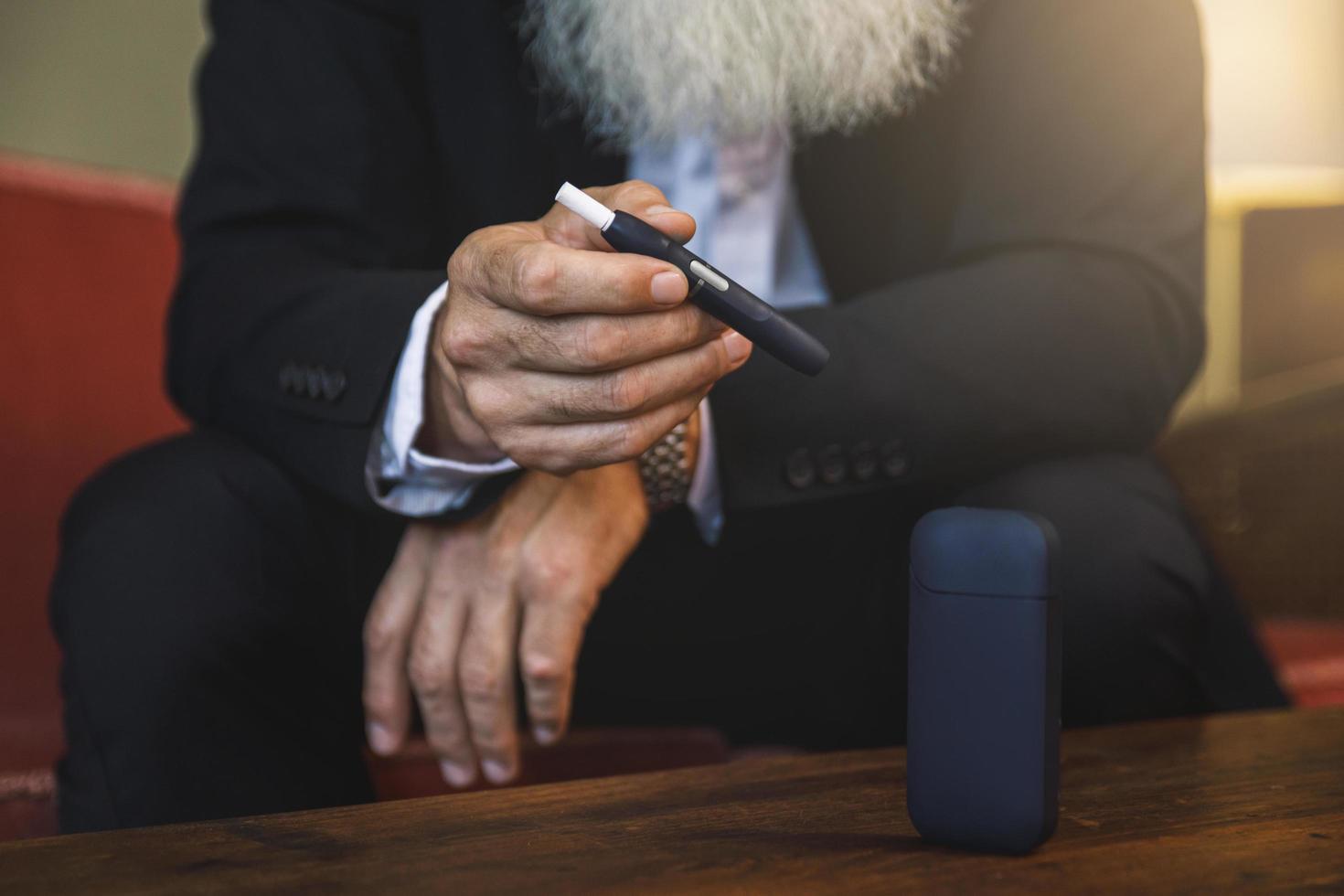 Man with a tobacco heating system in his hands photo