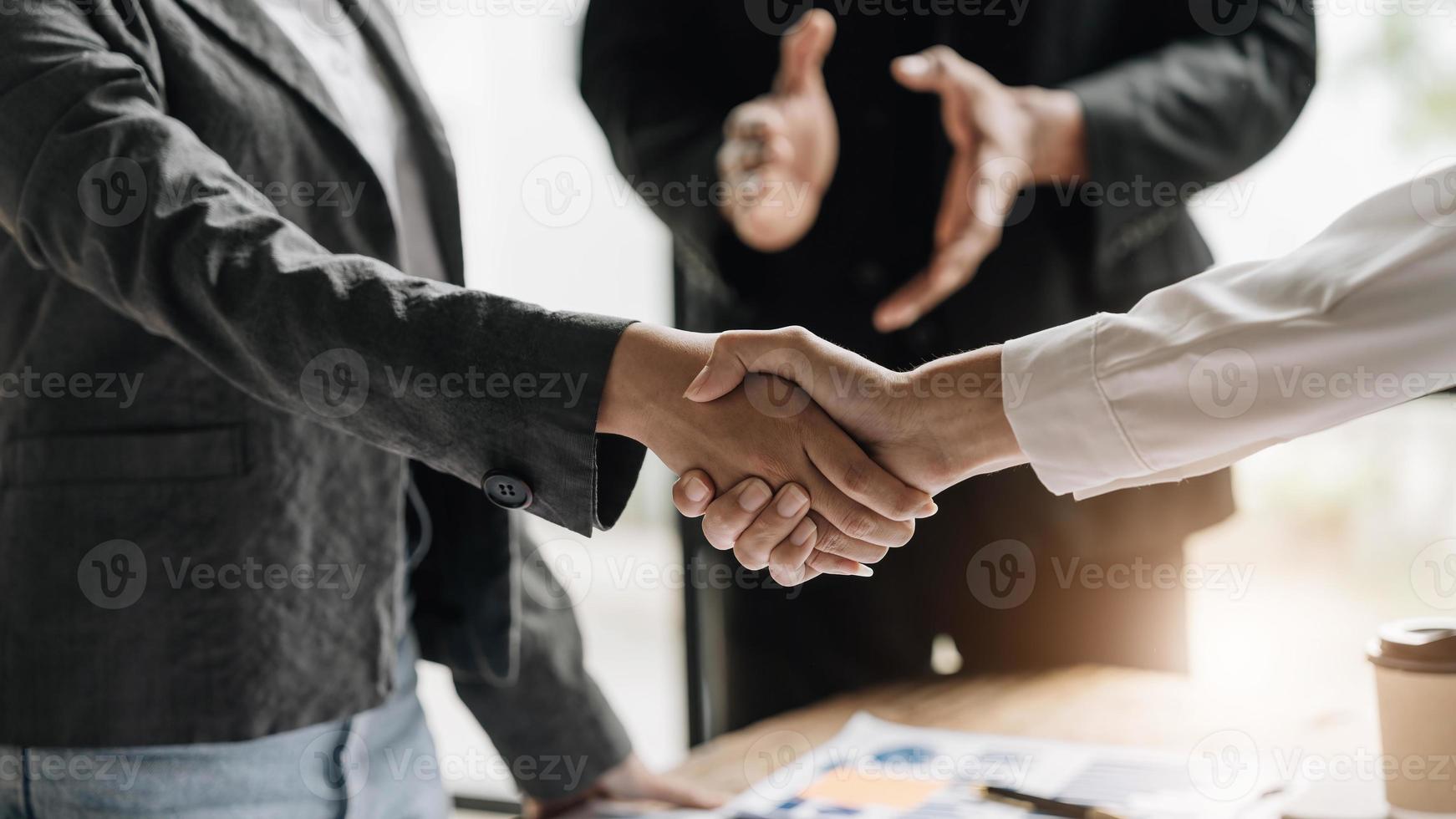 Business people shaking hands, finishing up meeting, business etiquette, congratulation, merger and acquisition concept photo