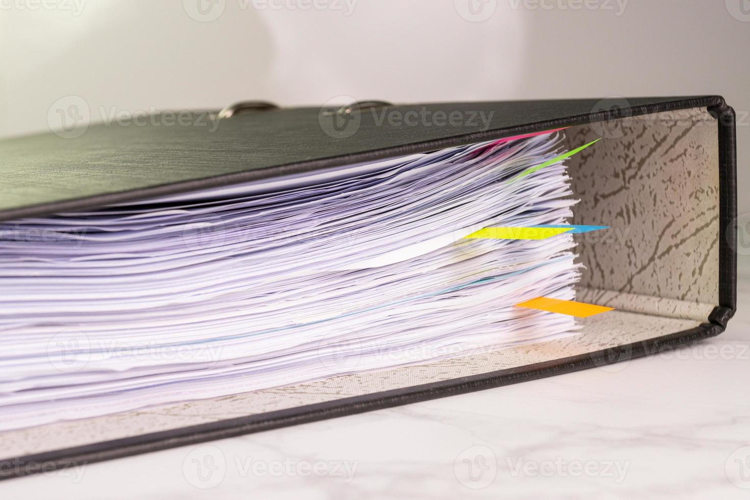 white paper stack in folder file for a business contract, income, expenses photo