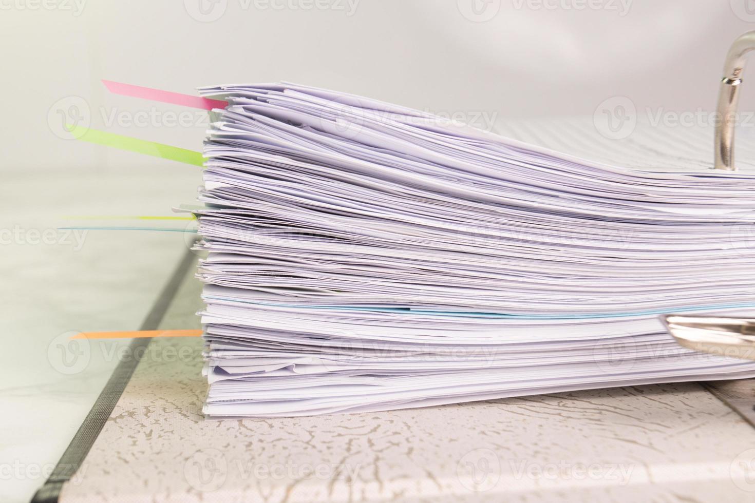 white paper stack in folder file for a business contract, income, expenses photo