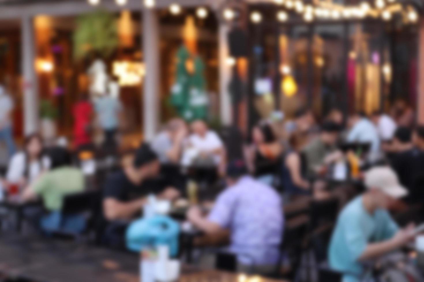 blurred image at the restaurant night time, many people in the restaurant eat and party happy relaxing photo