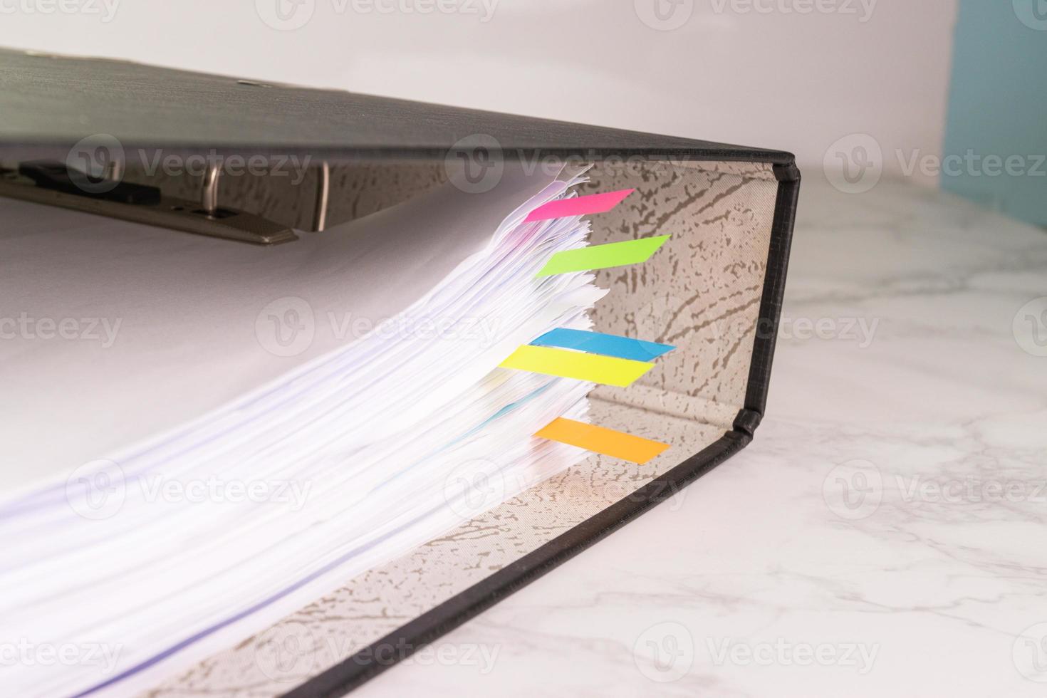 white paper stack in folder file for a business contract, income, expenses photo