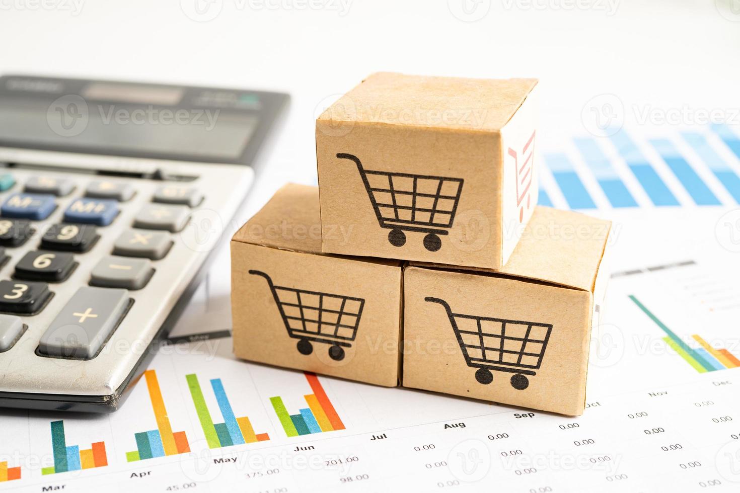 Shopping cart logo on box with magnifying glass on graph background. Banking Account, Investment Analytic research data economy, trading, Business import export transportation online company concept. photo