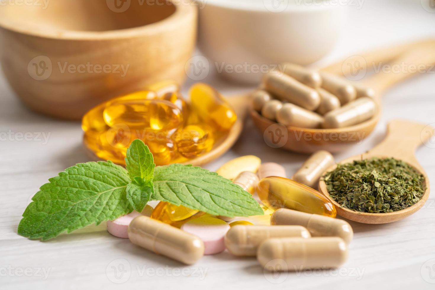 Alternative medicine herbal organic capsule with vitamin E omega 3 fish oil, mineral, drug with herbs leaf natural supplements for healthy good life. photo