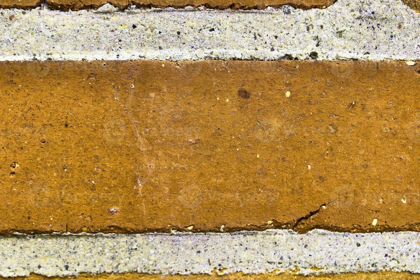 Detailed view at a colorful old and weathered brick wall texture as a panoramic background. photo