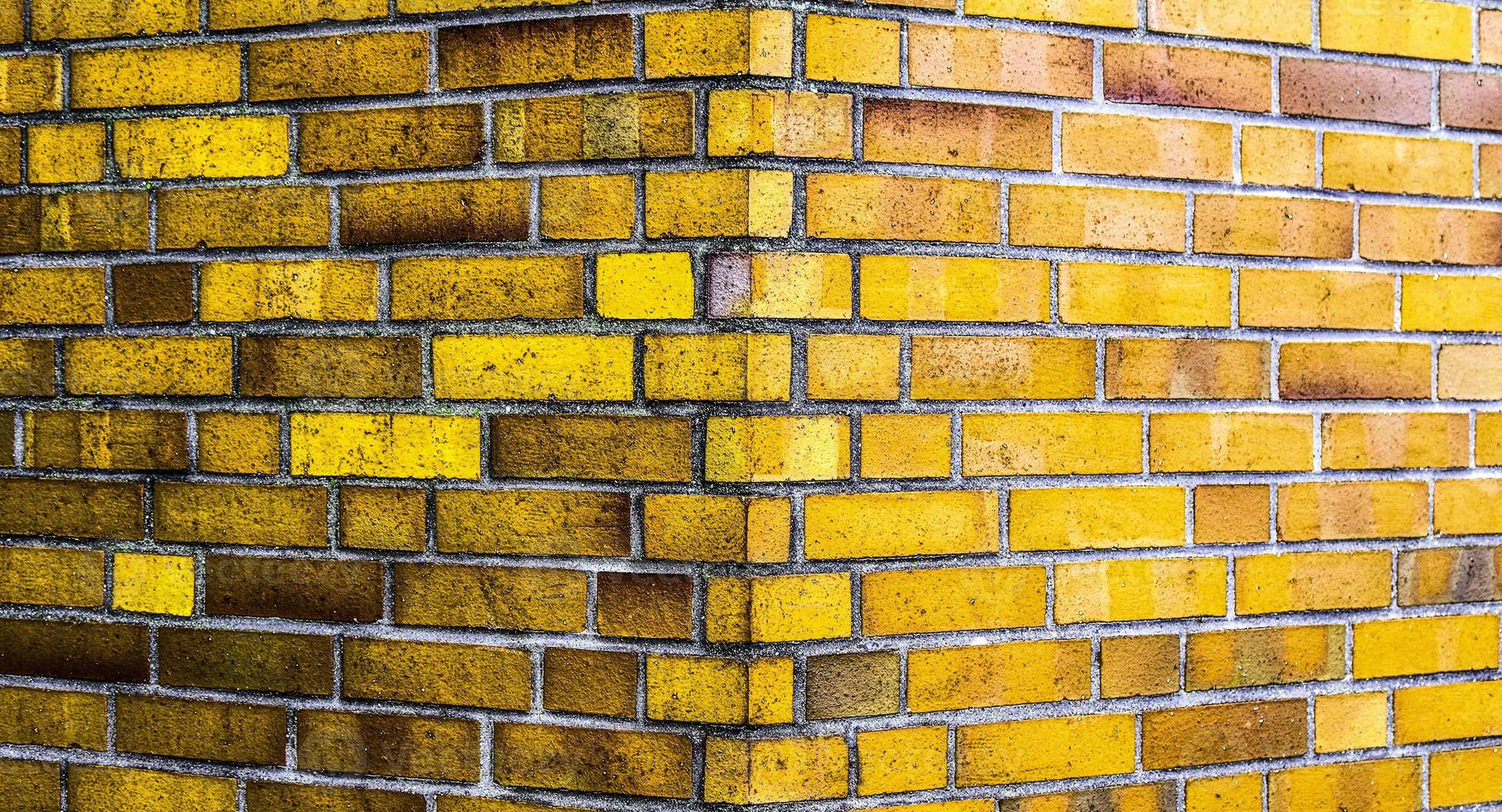 Detailed view at a colorful old and weathered brick wall texture as a panoramic background. photo