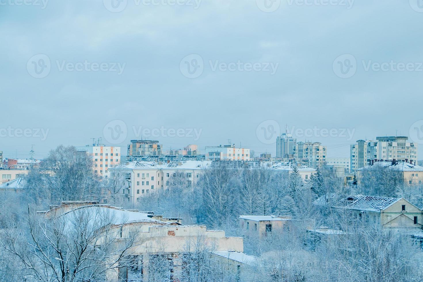 City view in winter. Houses and trees in snow. Beginning of  winter season. photo