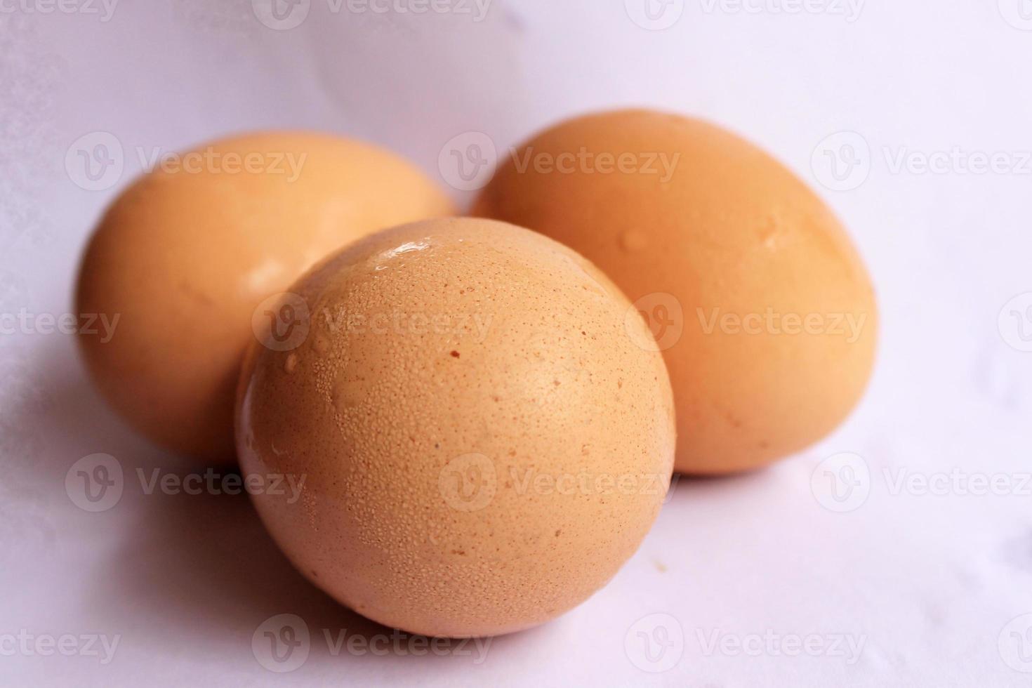 Three chicken eggs isolated white background. photo