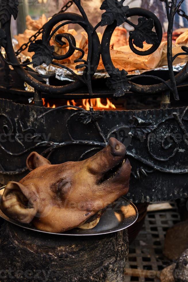 Smoked pig head on the street market photo