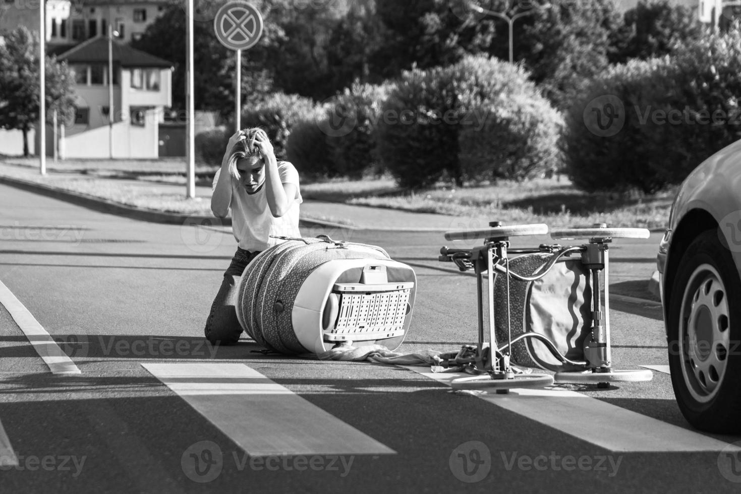 Shocked mother on the crosswalk after a car accident when a vehicle hits her baby pram. photo