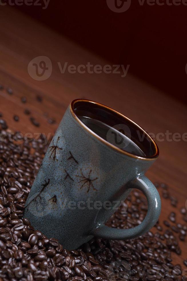 a cup of coffee with coffee beans photo