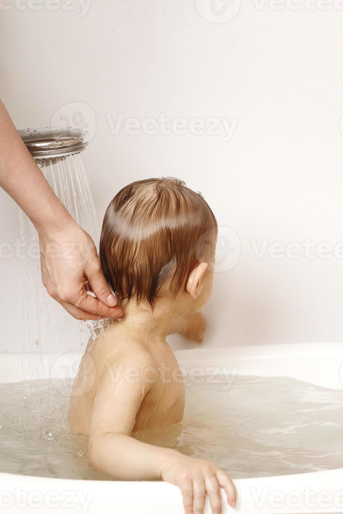 Mother washing and showering her little son. 14406509 Stock Photo at