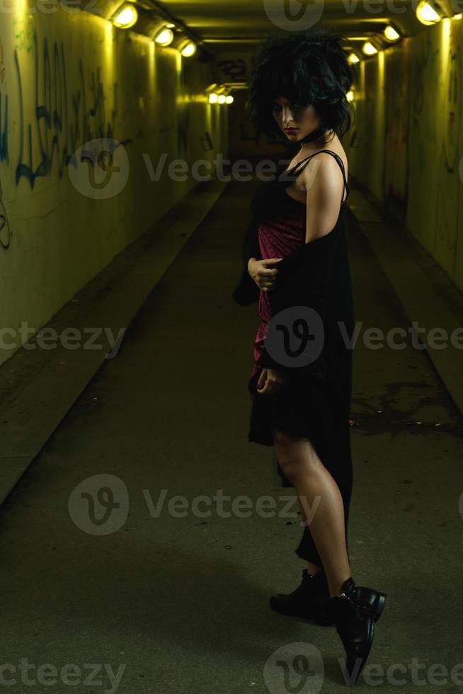 Strange and freaky woman in the dark tunnel photo