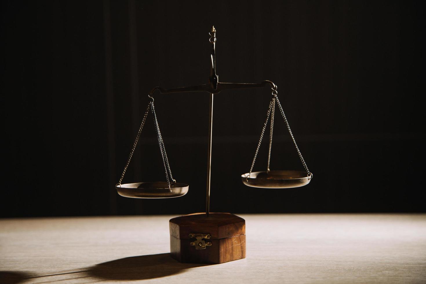 Justice and law concept.Male judge in a courtroom with the gavel, working with, computer and docking keyboard, eyeglasses, on table in morning light photo