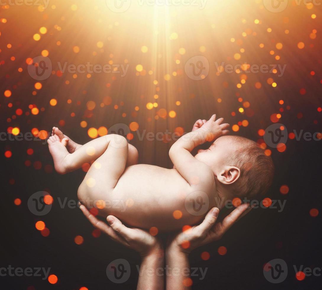 Cute newborn baby in the mother's hands photo