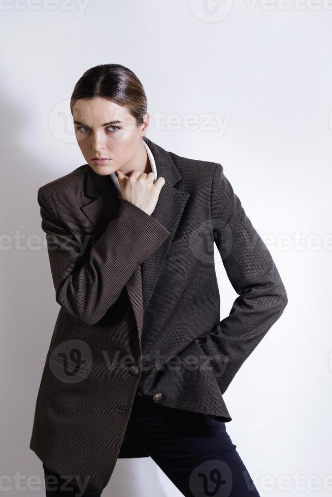 Fashionable studio portrait of young masculine woman photo
