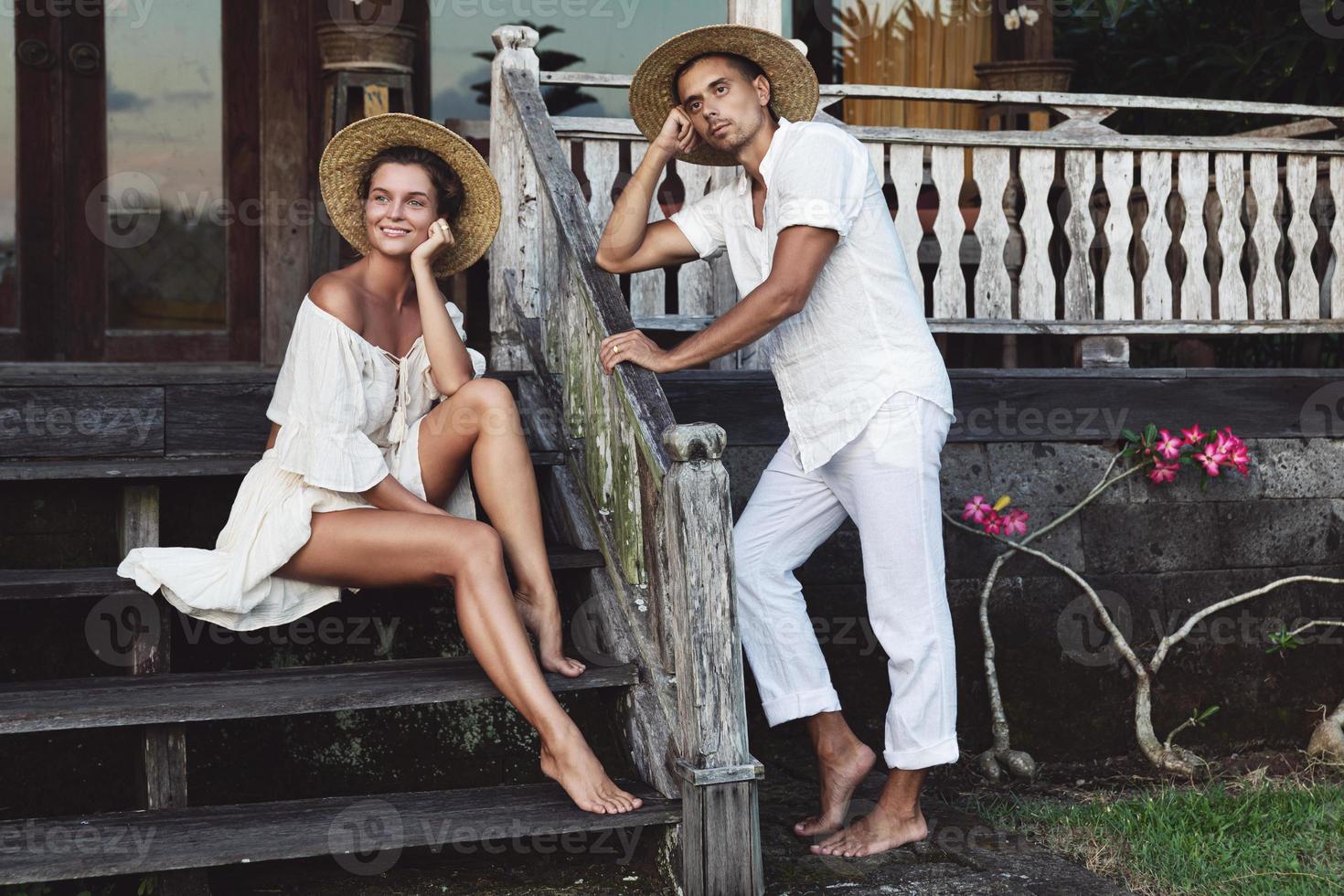 Young lovely couple sitting on the porch of their house photo