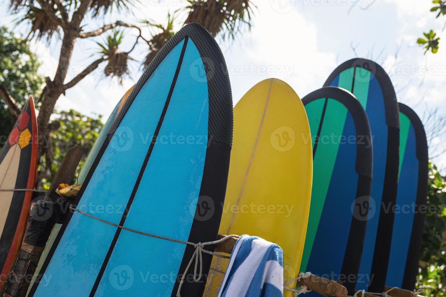 Stack of different surfboard for a rental on the beach photo