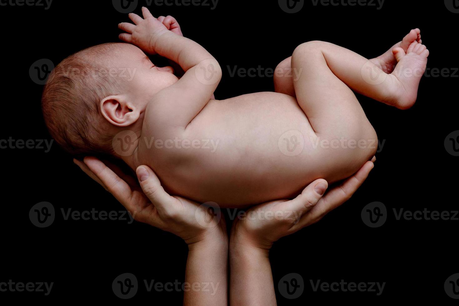 Cute newborn baby lying in the mother's hands photo