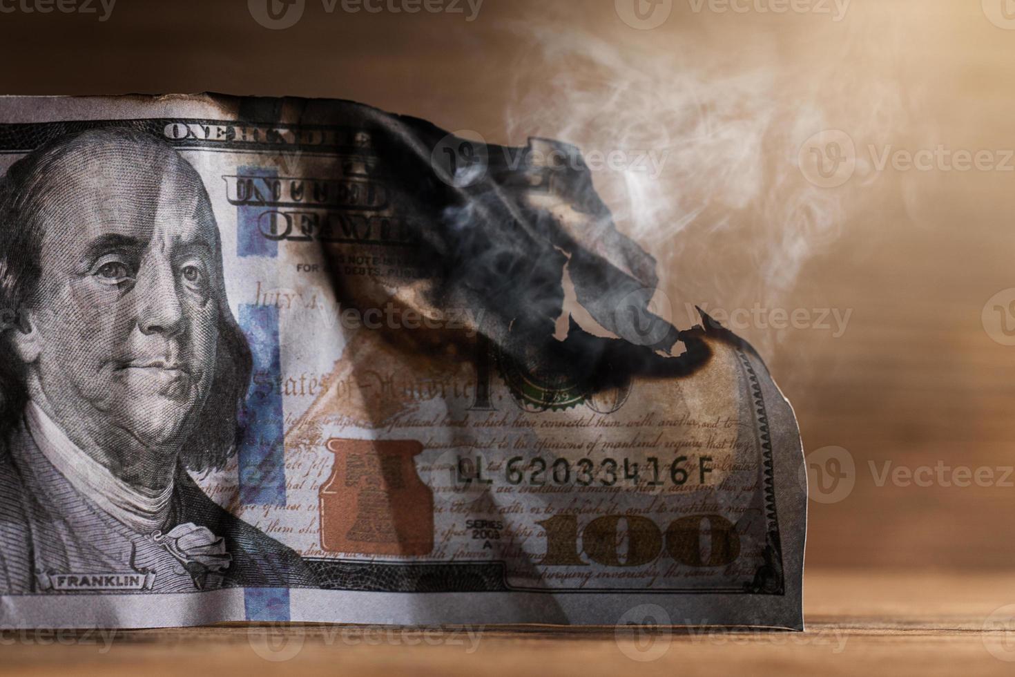 Closeup shot of burnt remainings of a one hundred dollar bill damaged in a fire photo