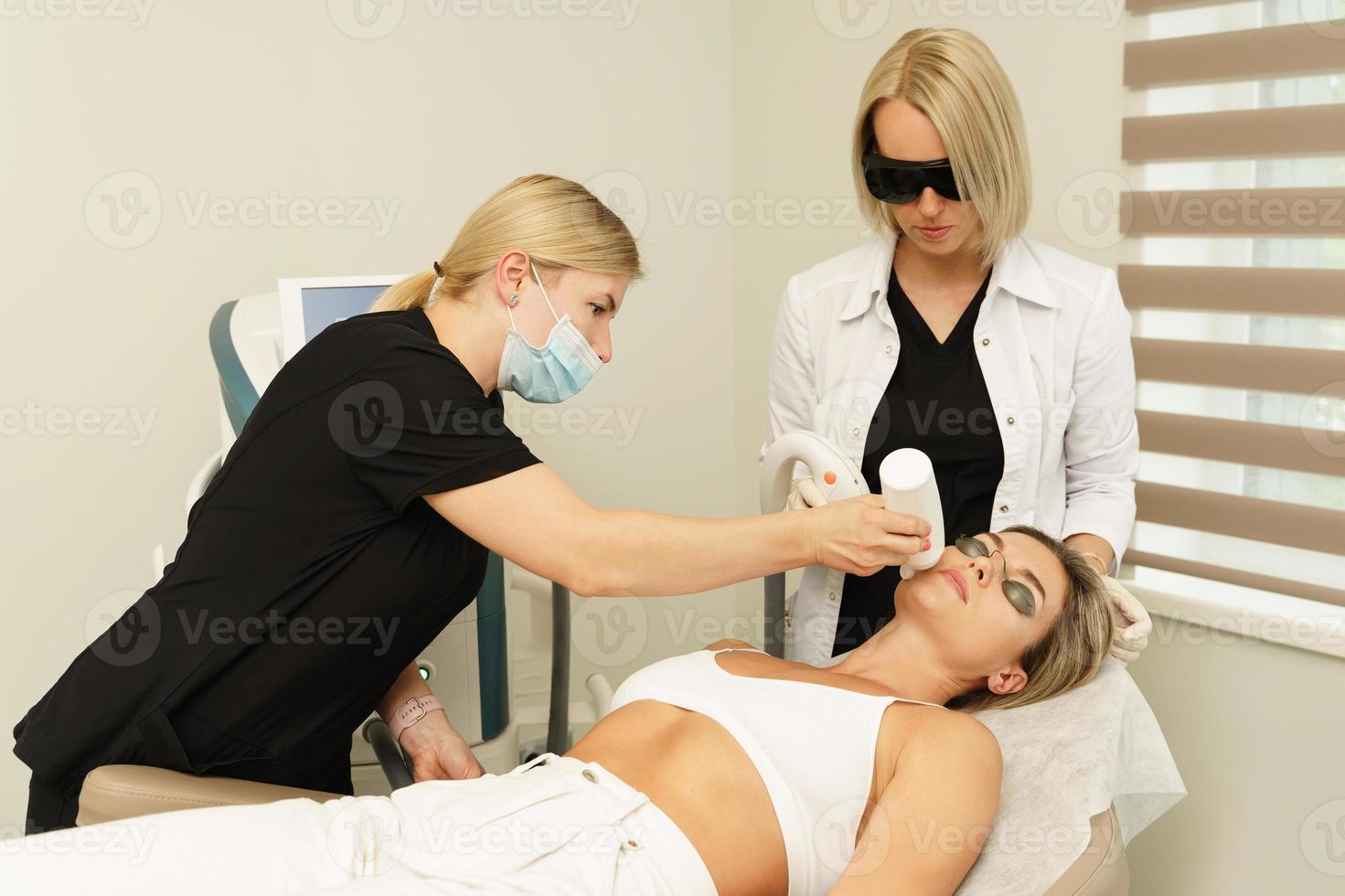 Woman client during IPL treatment in a cosmetology clinic photo