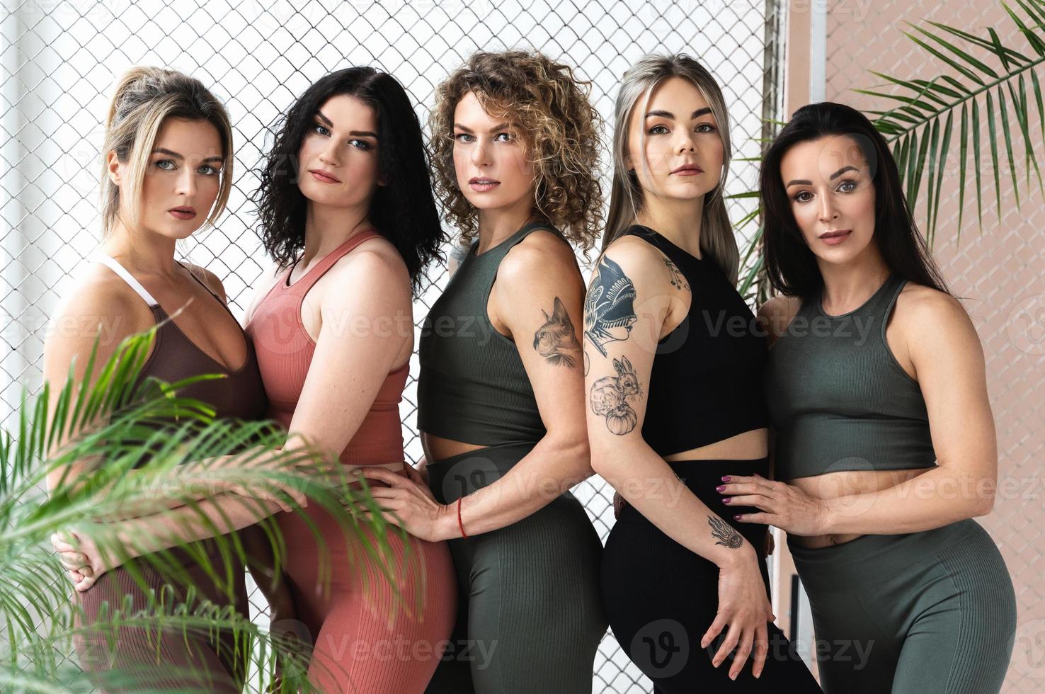 Group of sportive women wearing different sportswear photo