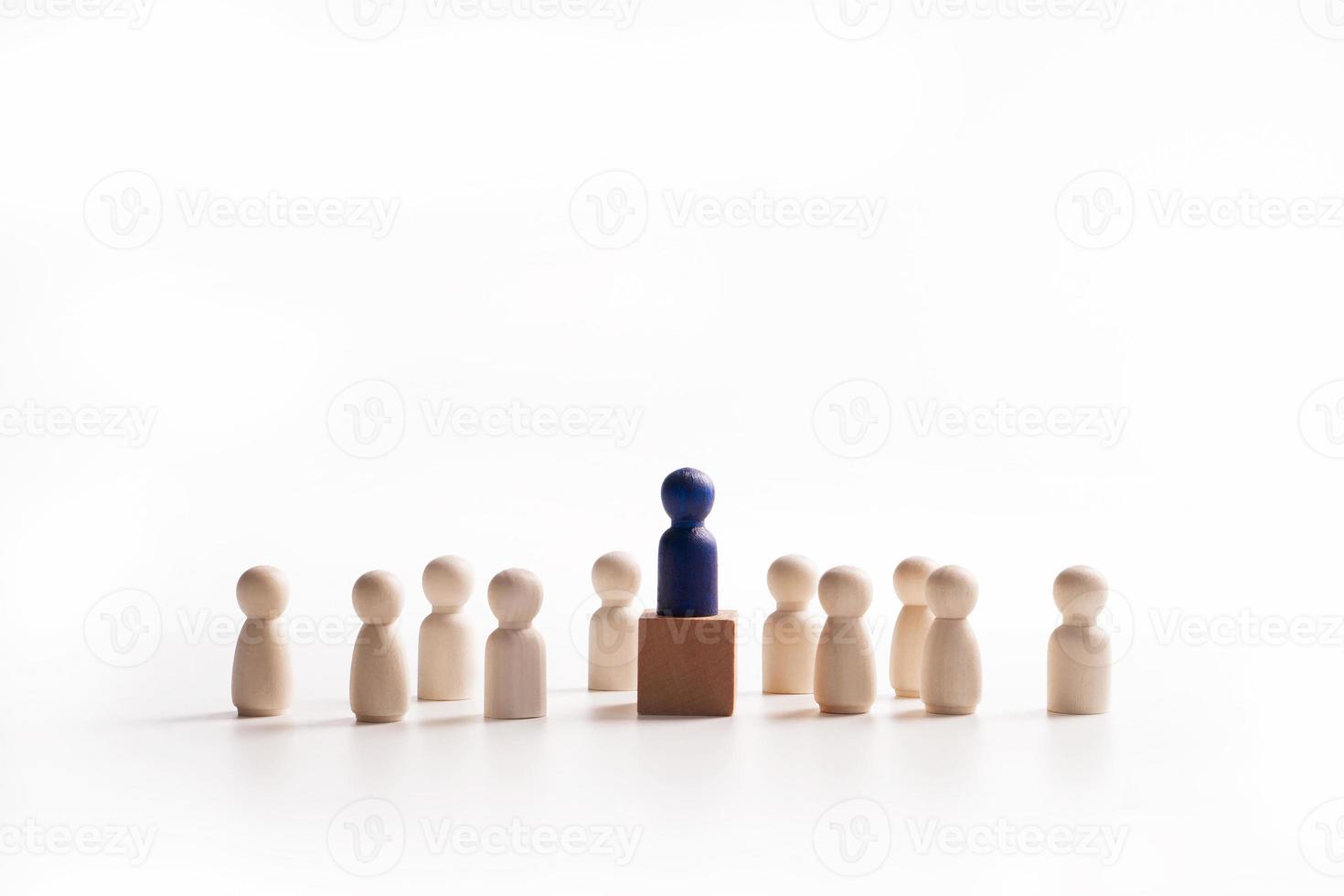 Wooden figure standing on the box for show influence and empowerment. Concept of business leadership for leader team, successful competition winner and Leader with influence photo