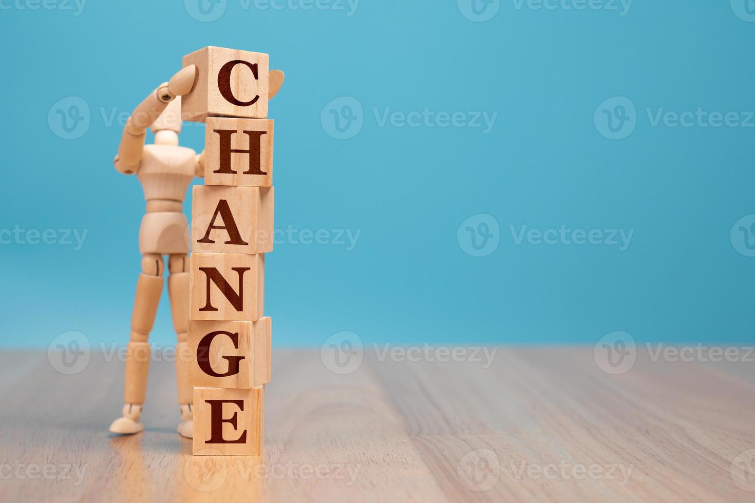 Wooden puppet standing and holding a wooden cube with word change to chance, Concept of self development for career, business success, and leadership photo